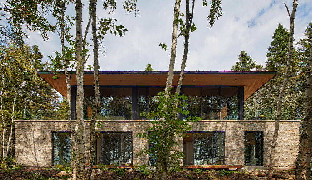 Nestled in a green setting, Villa Luce sits in harmony with the St. Lawrence River and Charlevoix mountains in Quebec