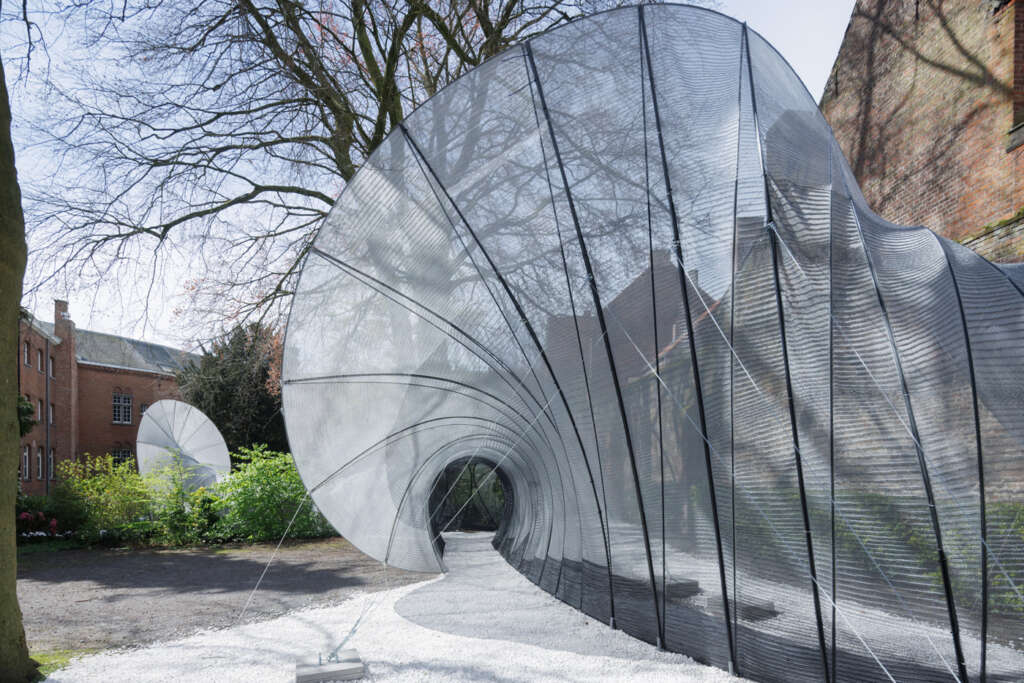 SO-IL design immersive passage made from 3D knit textile within 19th-century monastery courtyard in Bruges