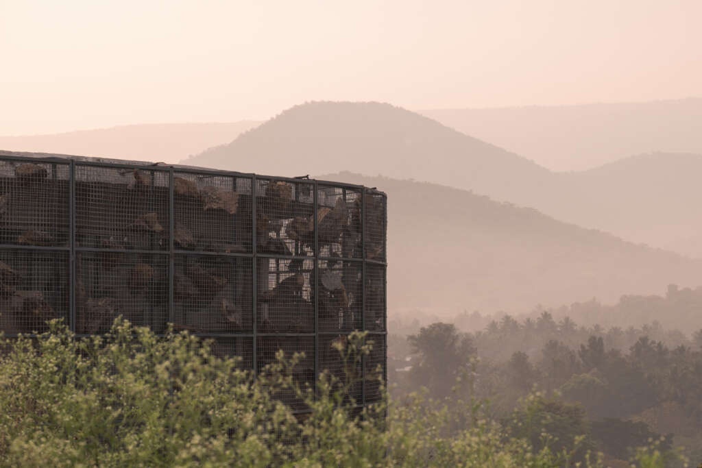 Earthscape Studio design circular home featuring floating rocks in a gabion wall