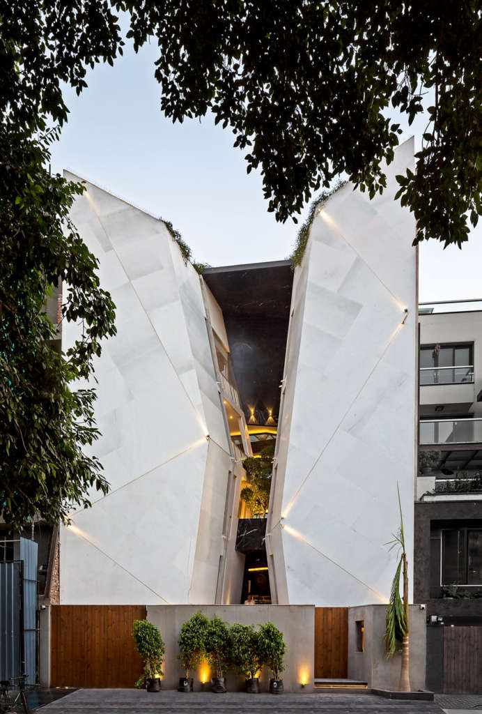 New Delhi home uses angled stone to draw natural light in