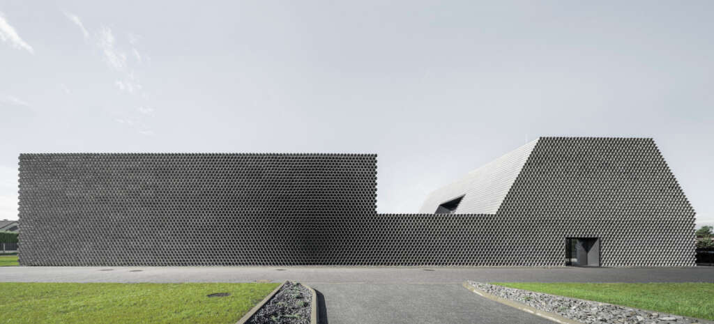 KWK Promes design office &amp; warehouse made out of stacked pipes