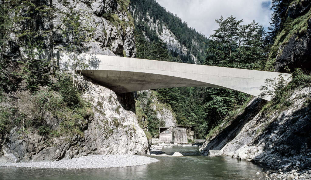 Marte.Marte Architects design twisting concrete bridge at the foot of a scenic mountain range