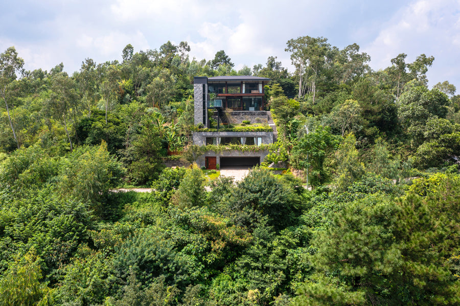 IDEE Architects design mountainside getaway with suspended bridge and pool