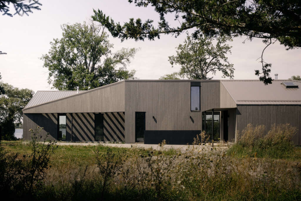 StudioAC design Prince Edward County getaway home that frame views of nearby shoreline