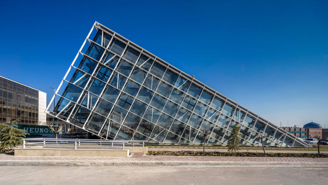 This Tehran office building features a sloped green roof and exterior structure