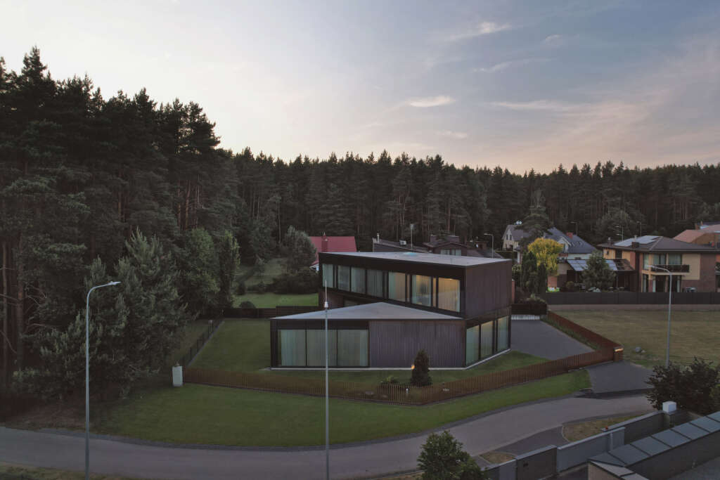 Architectural Bureau G.Natkevicius & Partners design angular house on the edge of a pine forest in Lithuania