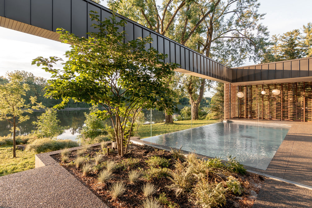 Residence de l'Isle is a single-family home built on the banks of a river in Montreal