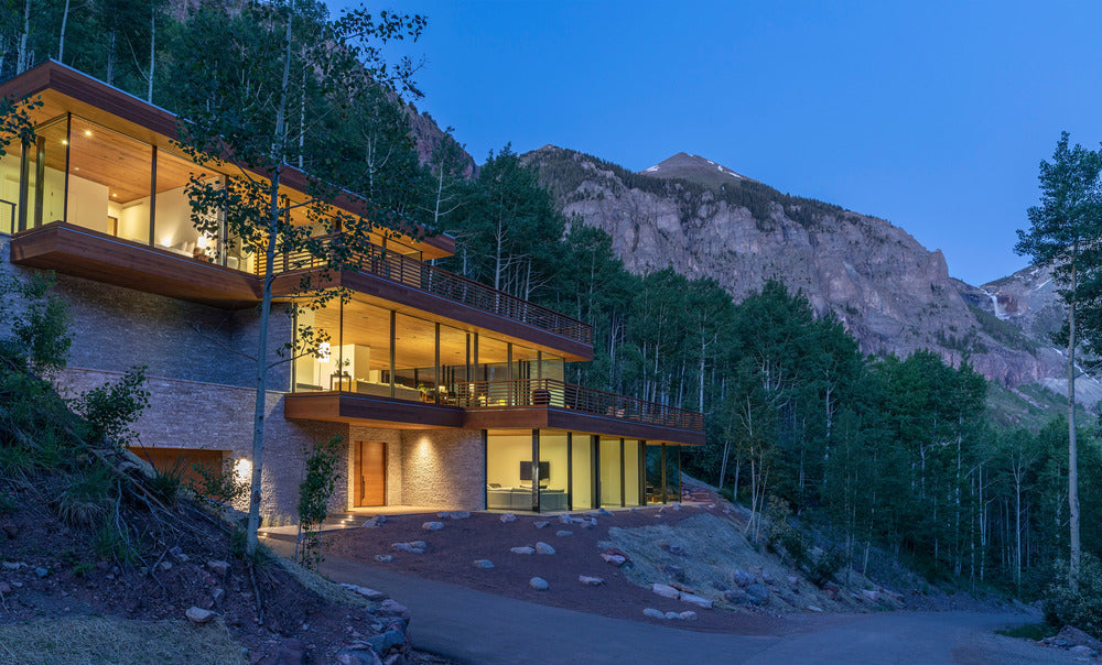 Escape to this glass home nestled into the steep cliffs of the Telluride Box Canyon in Colorado