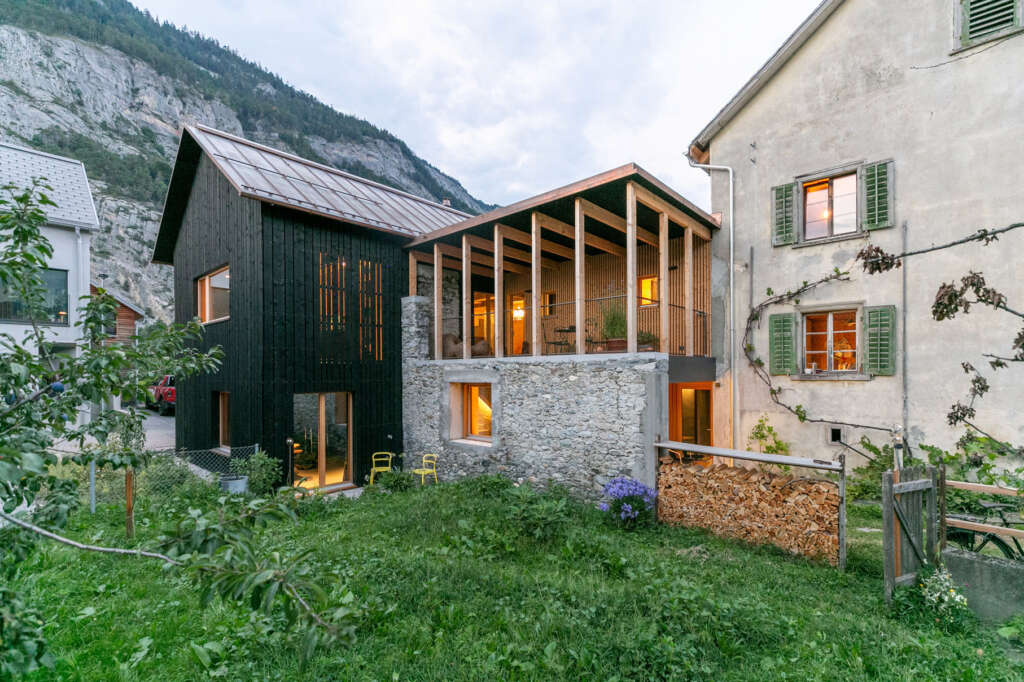 Modunita architects convert old hay barn into two new homes in Graubünden, Switzerland