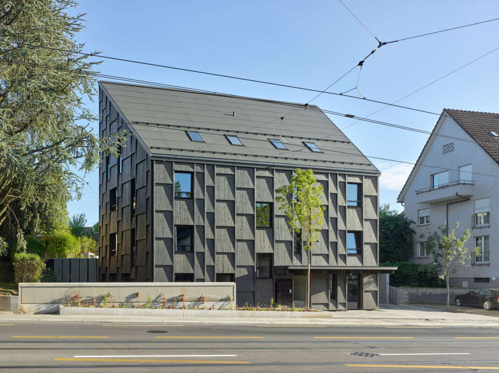 Rossetti+Wyss Architects design natural Zurich apartment with inclined wood panels and protected loggias