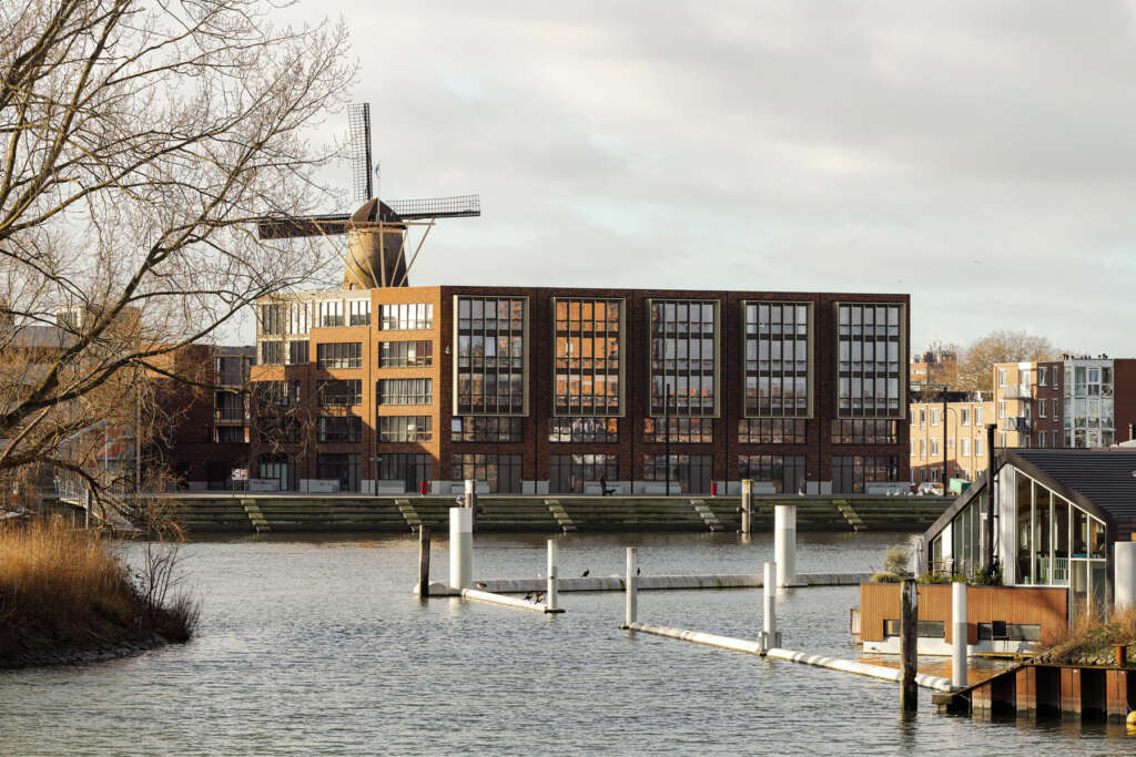 studio AAAN design brick and gold housing block near historic city center in Dordrecht