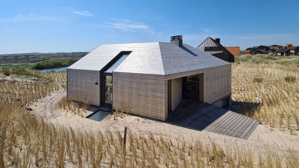 Escape to this breathtaking vacation home integrated into the dune landscape of West Aan Zee