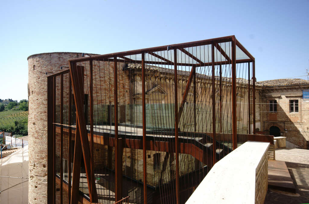Rocco Valentini Architecture design corten steel gate against medieval fortification