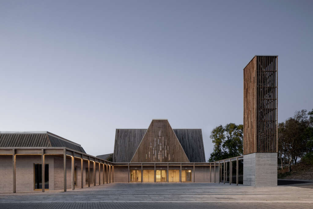 JAJA Architects and Brandsberg Dahl complete contemporary wood church with natural light filtering through gable roof