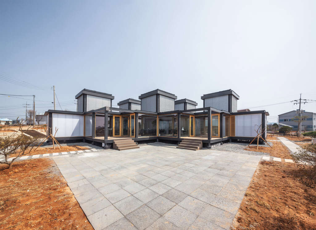 This village community center in South Korea is built in modules with glass towers