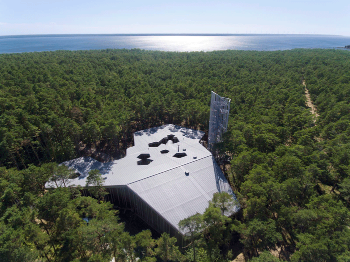 This Estonian muti-purpose center lies deep in the forest along the Baltic Sea