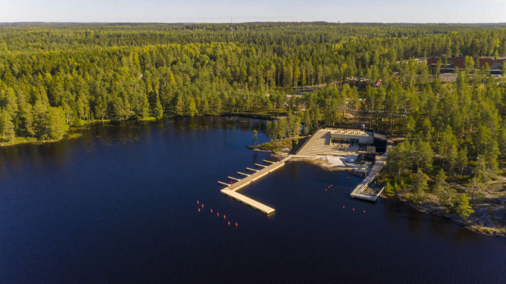 This restaurant & sauna in Finland features a stepped outdoor terrace on a lake
