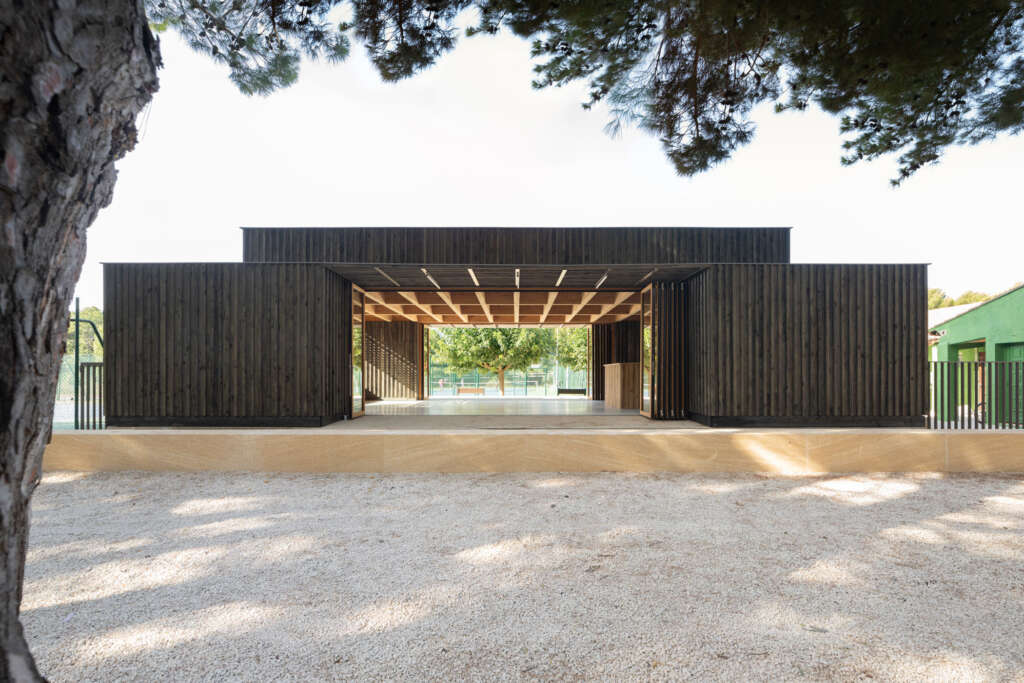 atelier Régis Roudil architectes design timber pavilion with folding doors for local tennis club