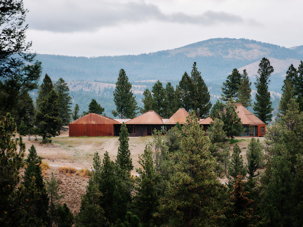 Inspired by the mountains of Montana, the Four Roof House is clad entirely in standing seam weathering steel