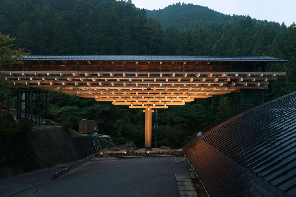 Wooden museum bridges a cliff and road