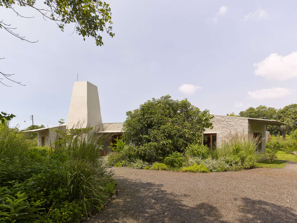 Case Design complete scattered weekend home that optimizes views to internal garden and the distant hills of Kankeshwar